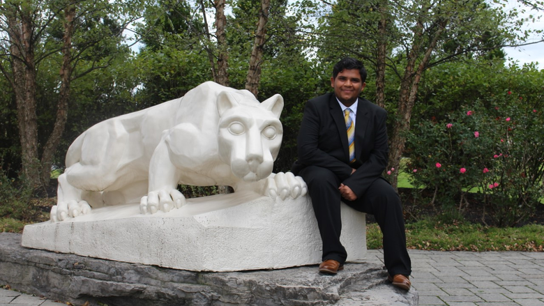 Hemil Patel in front of lion statue