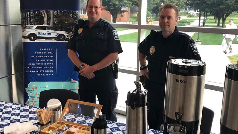 Officers setting up for coffee with a cop event.