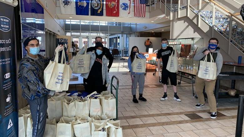 students and staff in Centre Hall gathering food items